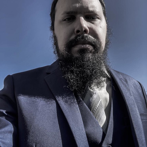 A bearded fellow in a blue suit